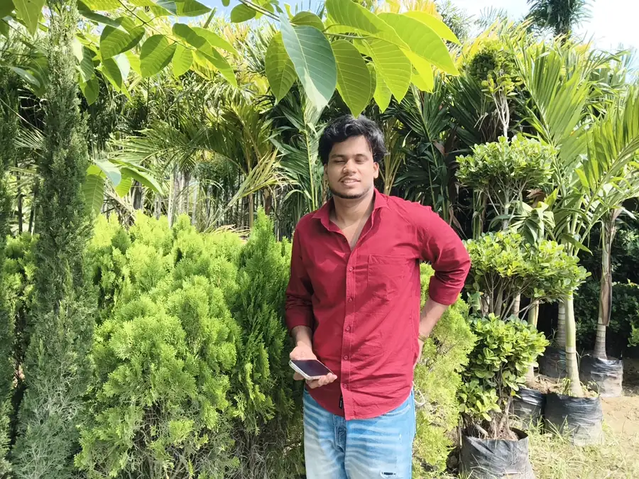 Standing among conifer shrubs and palms at LEAFFLIX Nursery